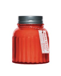 A tall, round, red glass candle jar with a silver metal lid. The candle is scented with a berry fragrance.