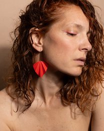 Red origami-style drop earrings with a modern, geometric design.