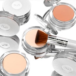 Starter set of face makeup products including a compact powder, blush, and makeup brush. The products feature a sleek, minimalist design in shades of white and silver.