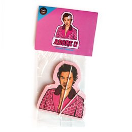 A pink air freshener in the shape of a person wearing a red patterned shirt.