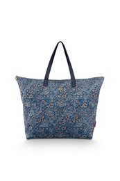  Large quilted tote bag in a blue floral print design with a navy blue trim and handles.