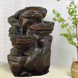 Tall, multi-level indoor and outdoor waterfall fountain with natural rock design, LED lighting, and flowing water feature for garden, terrace, or living room decor.