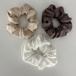 Cream-colored bamboo scrunchie with a soft, textured fabric.