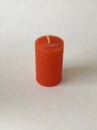 Rustic stumpen candle, 50 x 80 mm, pumpkin scented. Made of wax, cylindrical shape, orange color.