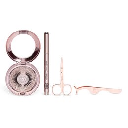 This makeup kit includes a compact with a round, shimmery eyeshadow palette, a black eyeliner pencil, and a pair of scissors for grooming lashes. The kit offers a range of looks from romantic to sensual, with product variants named "The Romantic," "The Femme Fatale," "The Crush," "The Lover," "The Sensual," and "The Flirt."