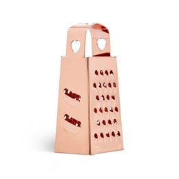 A rose gold-colored multifunctional grater with a heart-shaped design and various grating surfaces.