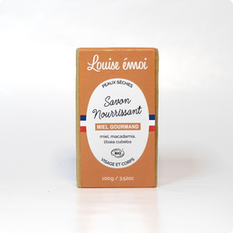  Savon Moussant (100g) - Honey-scented soap bar with natural ingredients.

The product is a honey-scented soap bar from the brand Louise Émoi. The soap bar is made with natural ingredients and has a rectangular shape. The packaging is orange in color and displays the product name and brand name prominently.