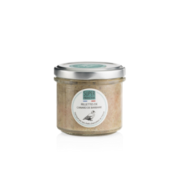 Muscovy duck rillettes in a glass jar. The rillettes are a savory spread made from shredded Muscovy duck meat. The jar has a green lid and a label with the product name.