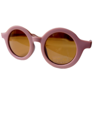 Round pink kids sunglasses with amber lenses.
