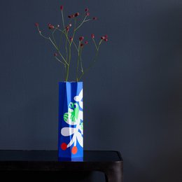 Large papaya-colored vase with abstract geometric patterns in various colors including pink, green, and orange.