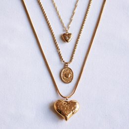 Twisted steel chain with an oval heart charm