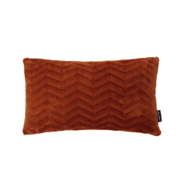 A small decorative cushion in a rust terra color, featuring a chevron pattern design. The cushion is rectangular in shape and appears to be made of a soft, textured fabric.