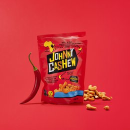 Roasted cashew nuts with a spicy chili flavor, packaged in a bright red bag.