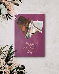 A Valentine's Day card featuring a white horse with a brown mane against a pink background. The card has the text "Happy Valentine's Day" written on it.