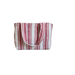 A large, striped beach bag in shades of red, pink, and white. The bag has a simple, rectangular shape and a sturdy canvas material.