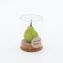  A glass dome with a green pear inside, resting on a wooden base with a label that says "Toffee pear".