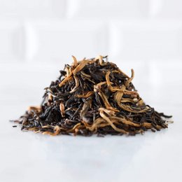 Finest Yunnan Golden Black - FOP tea, a high-quality black tea with a rich, full-bodied flavor and golden tips.

The Finest Yunnan Golden Black - FOP tea is a premium black tea from the Yunnan region of China. The tea leaves have a dark brown color with golden tips, indicating a high-quality tea. This tea has a rich, full-bodied flavor with notes of malt and a slight sweetness. The tea is available in different packaging sizes, including a 90-gram resealable pouch and a 400-gram resealable pouch, as well as a 90-gram tin.
