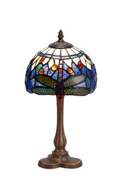 A decorative table lamp with a Tiffany-style glass shade featuring a dragonfly design in shades of blue, amber, and green. The lamp has a bronze-colored metal base.