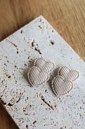  Beige corduroy hair clips in the shape of hearts, featuring a textured surface and a subtle striped pattern.