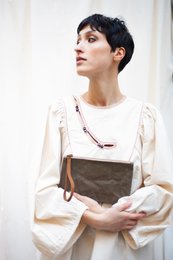 Beige and brown leather clutch with taiga pattern, suitable for casual or formal occasions.