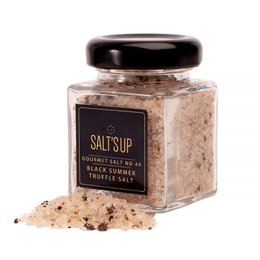  Coarse black summer truffle salt in a glass jar. The salt has a rich, earthy flavor and aroma from the black summer truffles.