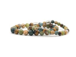 A set of two bracelets featuring a mix of natural stone beads in earthy tones, including amber, jasper, and agate. The bracelets are designed for couples and feature the text "MR. & MRS." engraved on the metal charms.