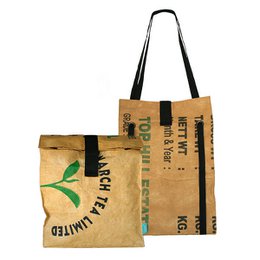  A large, beige backpack-style shopper bag made from recycled materials. The bag has a green leaf logo and the text "March for the planet" printed on the front.