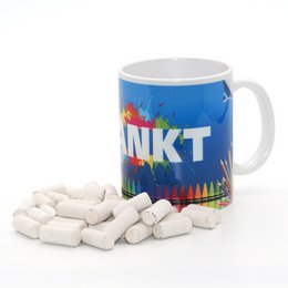 Colorful mug with the text "INKT" and crayons spilling out, suitable for storing and displaying art supplies.
