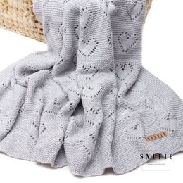 Soft, knitted baby blanket in grey color with heart-shaped pattern. Made of high-quality materials for warmth and comfort.