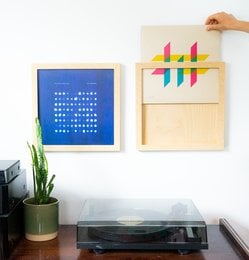 Wooden wall-mounted vinyl record holder with abstract geometric design.