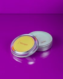 Medium-sized, round, yellow scented soy candles in silver containers with the label "Mango".