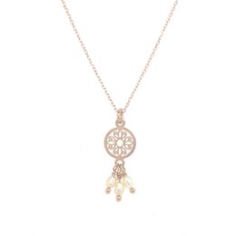 Elegant gold-toned necklace with layered charms, including a round pendant and pearl accent.