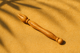  Olive wood cheese knife with natural wood grain, fork-shaped prong, rustic wooden handle, artisanal design.