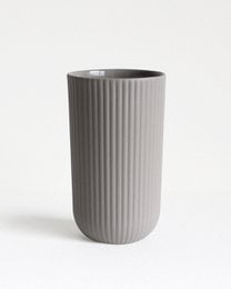 Dark gray ceramic mug with vertical ribbed texture, suitable for hot and cold beverages.