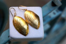 Handmade silver sea shell earrings in a boho style, available in silver or gold, with a unique and natural shape.