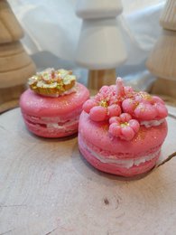  A white, ceramic Santa Claus candle with a jolly, round shape and a long, white beard. The candle is surrounded by small, decorative Christmas trees, creating a festive holiday scene.
