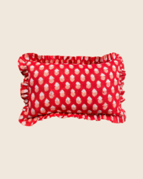  Rectangular cushion with a sunset motif and polka dot pattern in shades of red.