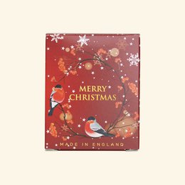 Scented candle 170g - Merry Christmas. A round, tall candle with a festive red and white design featuring snowflakes and a bird. The candle is made in England and has a Merry Christmas label.