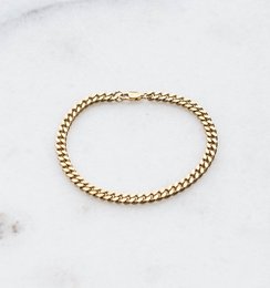 A simple chain bracelet made of sterling silver or 24k gold plated metal, featuring a classic curb chain design.