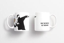 A ceramic mug featuring the iconic Banksy artwork "The Flower Thrower". The mug has a black and white design with the text "FIGHT THE POWER, NOT THE WARS" printed on it.