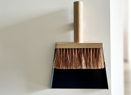 A wooden brush and dustpan set with a natural bristle brush and a black dustpan. Suitable for cleaning and sweeping.