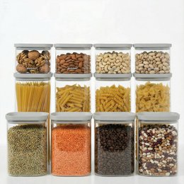  Set of 9 clear glass storage jars with gray lids, including 1 set free. The jars are suitable for storing a variety of dry goods such as pasta, coffee beans, and other pantry items.