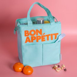  Mint green isothermic lunch bag with "Bon Appetit" text in orange. The bag has a rectangular shape and a top handle for carrying. It appears to be made of a durable, insulated material suitable for keeping food and drinks at the desired temperature.