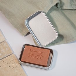 Rectangular metal soap dish with a brown soap bar inside. The soap dish has a simple, minimalist design suitable for travel or everyday use.