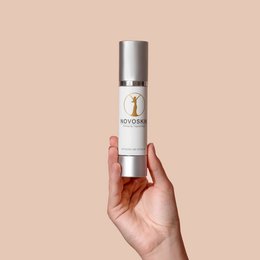 Antiaging day care cream in a silver bottle. The cream is designed to provide anti-aging benefits and care for the skin.