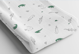  Soft, breathable 100% cotton muslin baby blanket with a crocodile print pattern. Ideal for swaddling, strolling, or tummy time.