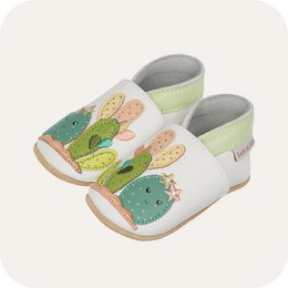  Soft leather baby slippers with cactus design, available in sizes 0-6 months to 3-4 years. Features colorful cactus illustrations in shades of green, pink, and yellow.