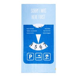 Blue beach towel with text "SORRY I WAS HERE FIRST" and parking disc icon. Rectangular shape, soft and absorbent material.