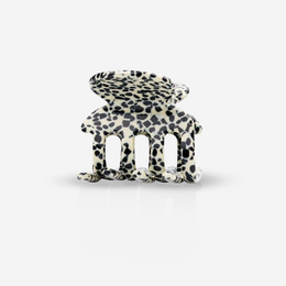 A black and white leopard print hair clip with a unique abstract shape.