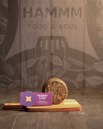 "Artisanal pecorino cheese with olive leaves, creamy pale yellow wedge, gourmet Italian cheese"